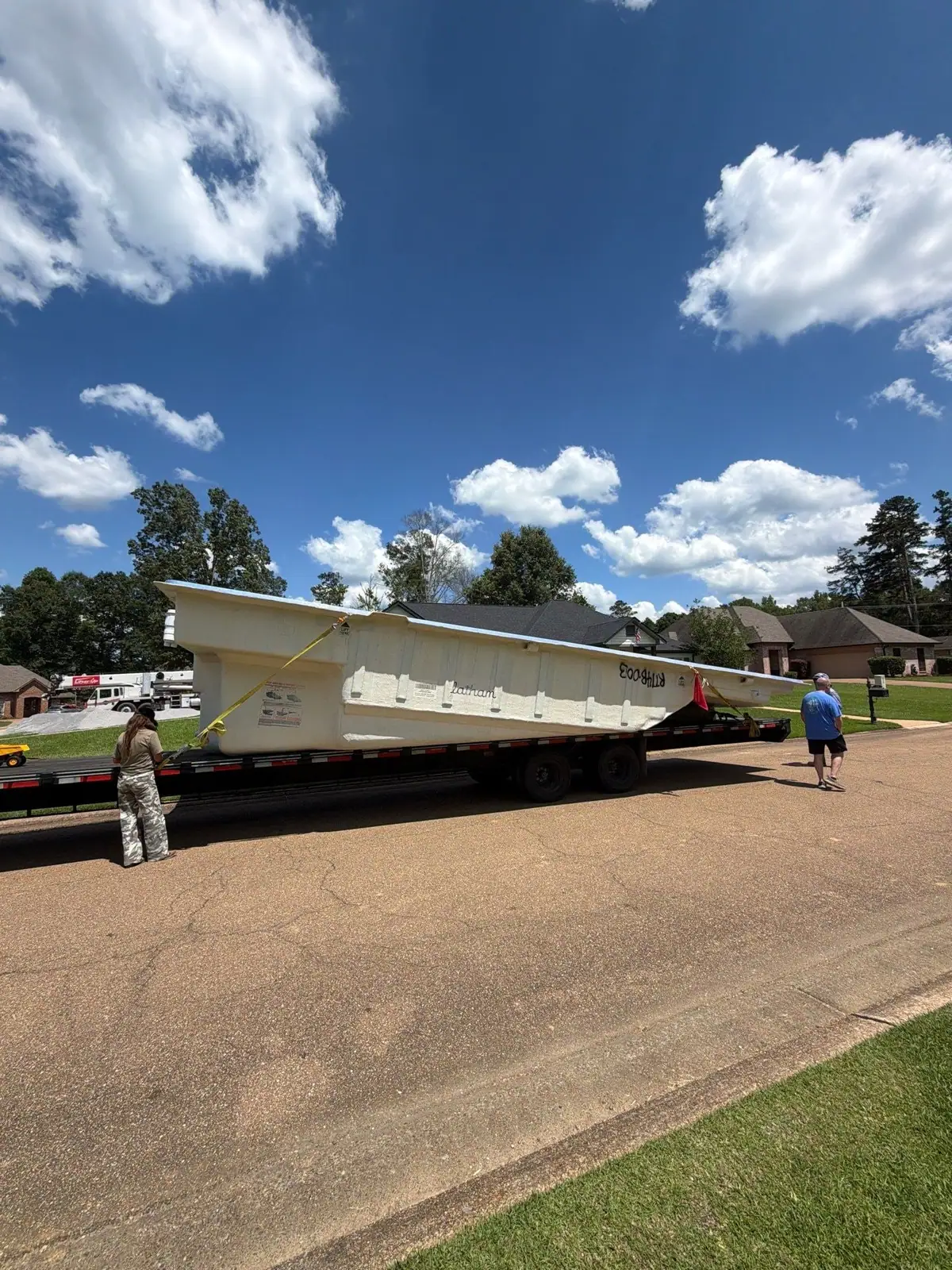 Latham fiberglass pool shell arriving on its trailer, DC Pools and Spas pool company serving Clinton, MS