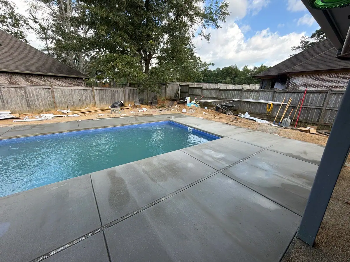 Newly filled inground fiberglass pool with its deck, inground pool builders serving Clinton, MS