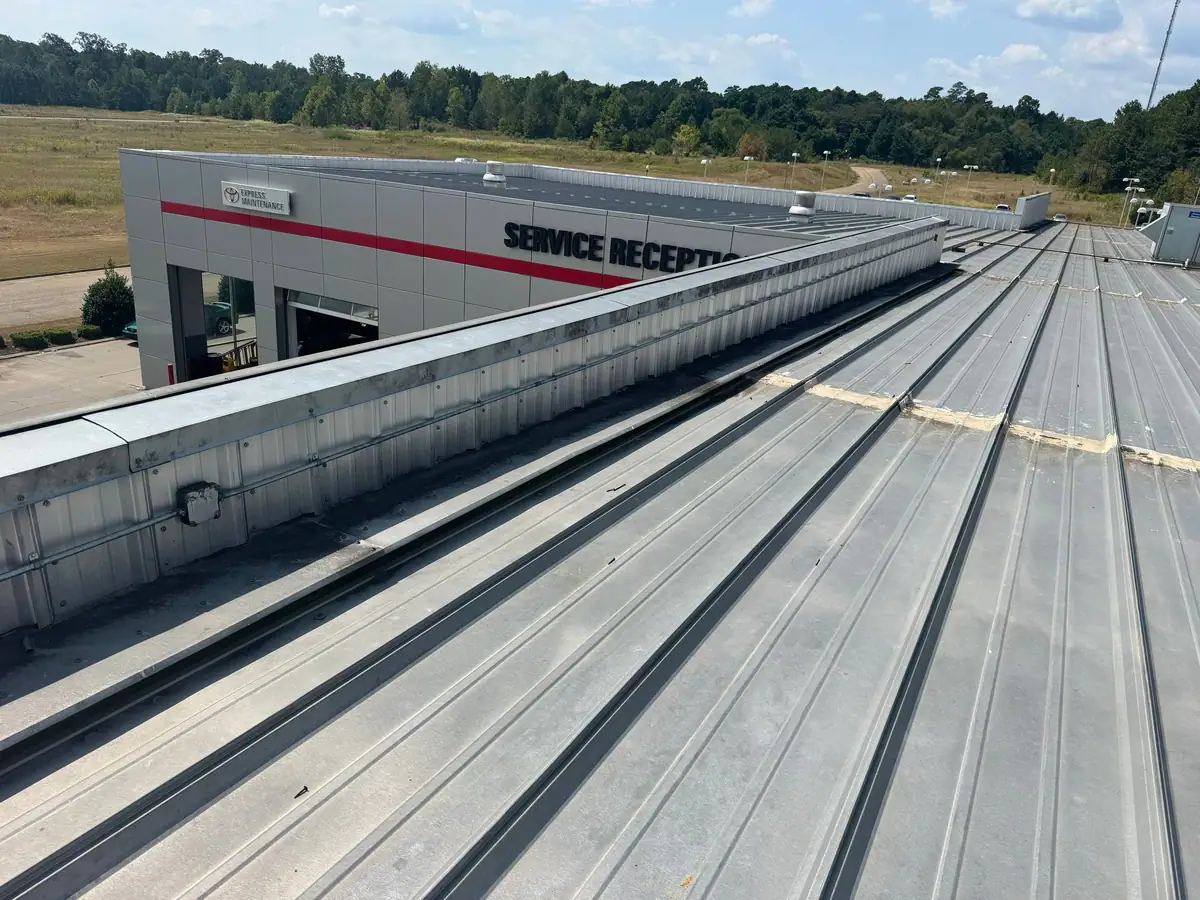 New metal roof panels along a commercial service building, metal roofing by Dickerson Contracting serving Clinton, MS