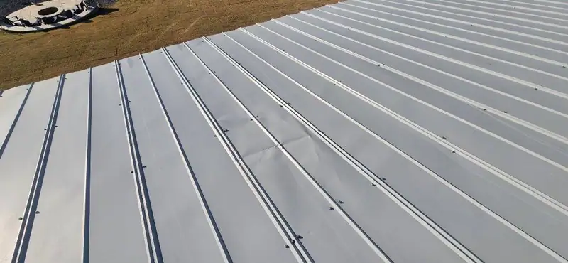 Finished standing seam metal roof planes meeting at a valley, metal roofing by Dickerson Contracting serving Clinton, MS