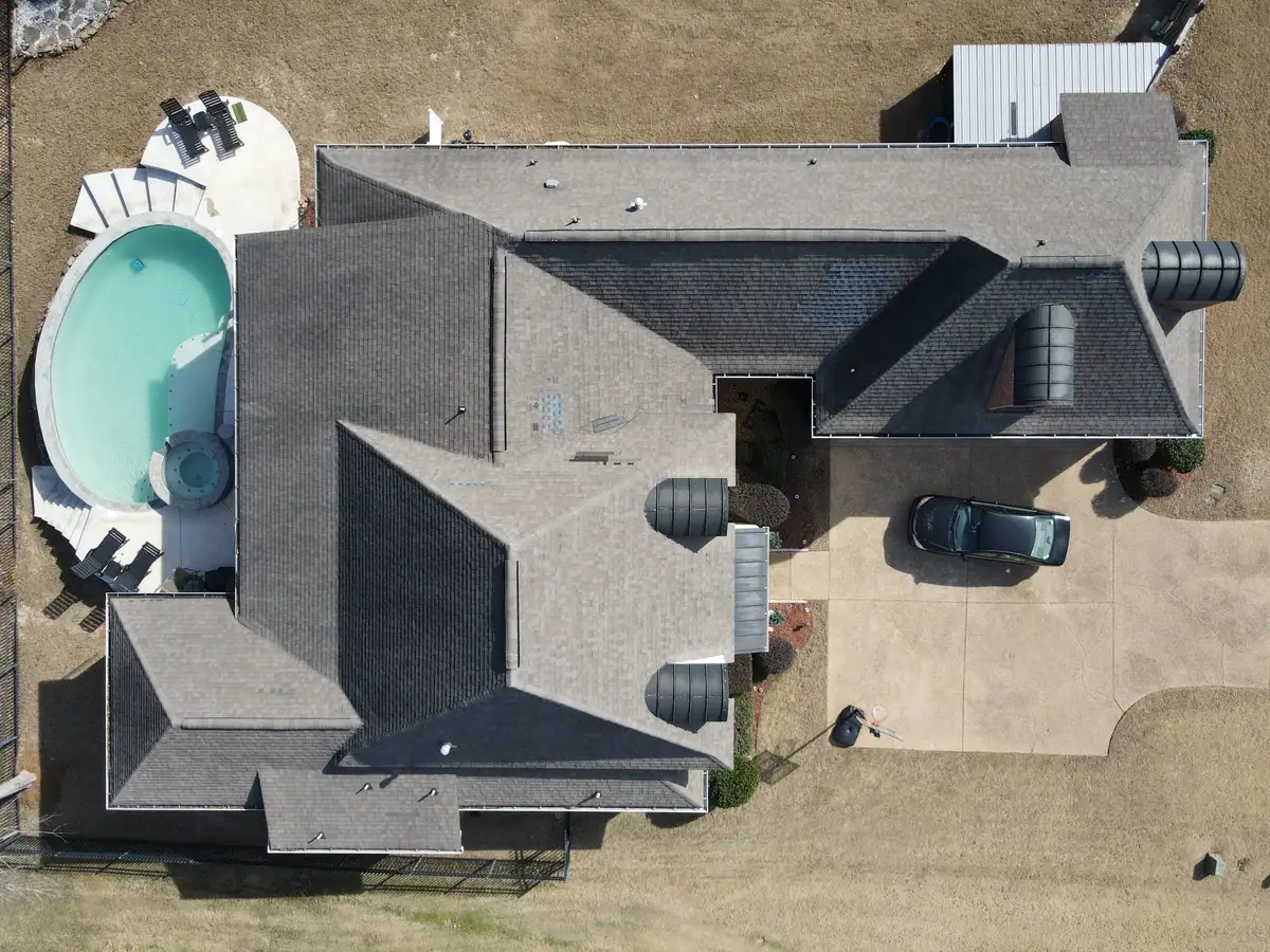 Large home with a new shingle roof and a pool, residential roofing by Dickerson Contracting serving Clinton, MS