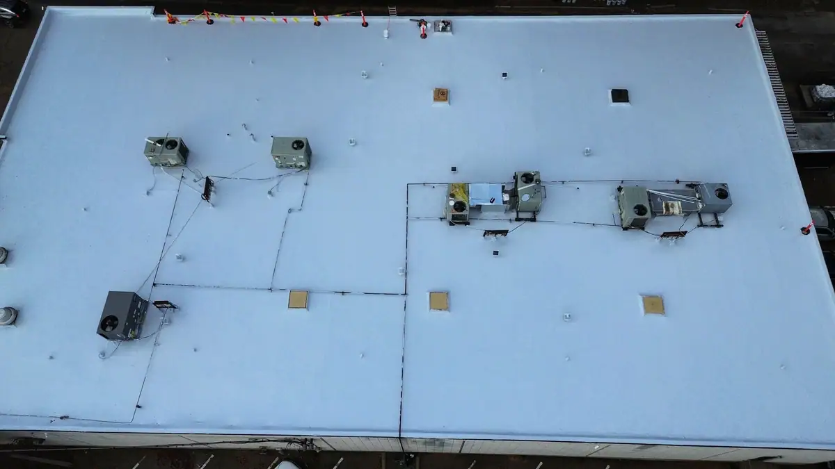 Aerial view of a finished white TPO roof on a commercial building, commercial roofing by Dickerson Contracting in Flowood, MS