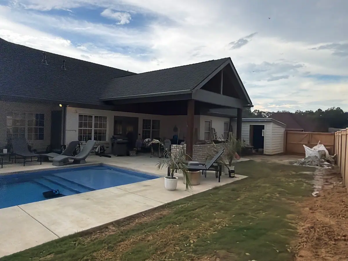 Inground fiberglass pool beside a covered back porch, inground pool installation serving Flowood, MS