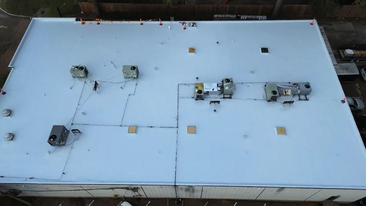 White TPO membrane roof on a commercial building, from above, commercial roofing by Dickerson Contracting in Jackson, MS