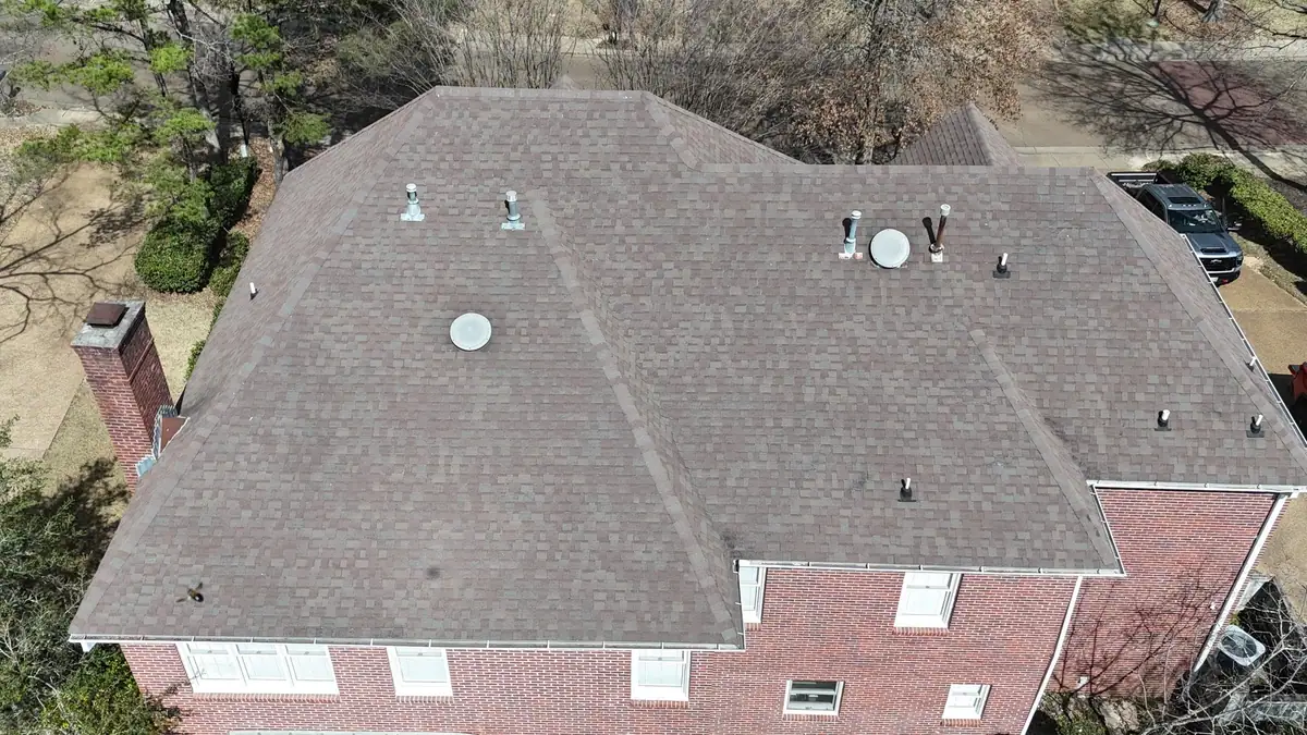 Finished shingle roof on a two-story brick home from above, residential roofing serving Jackson, MS