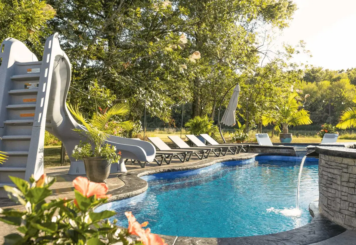 Fiberglass pool with a slide and waterfall (Latham photo), pool company DC Pools and Spas serving Madison, MS
