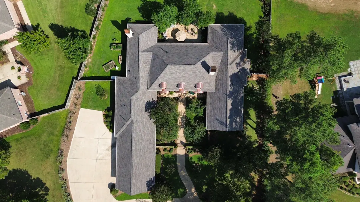 Large home with a finished shingle roof and courtyard, residential roofing by Dickerson Contracting serving Madison, MS