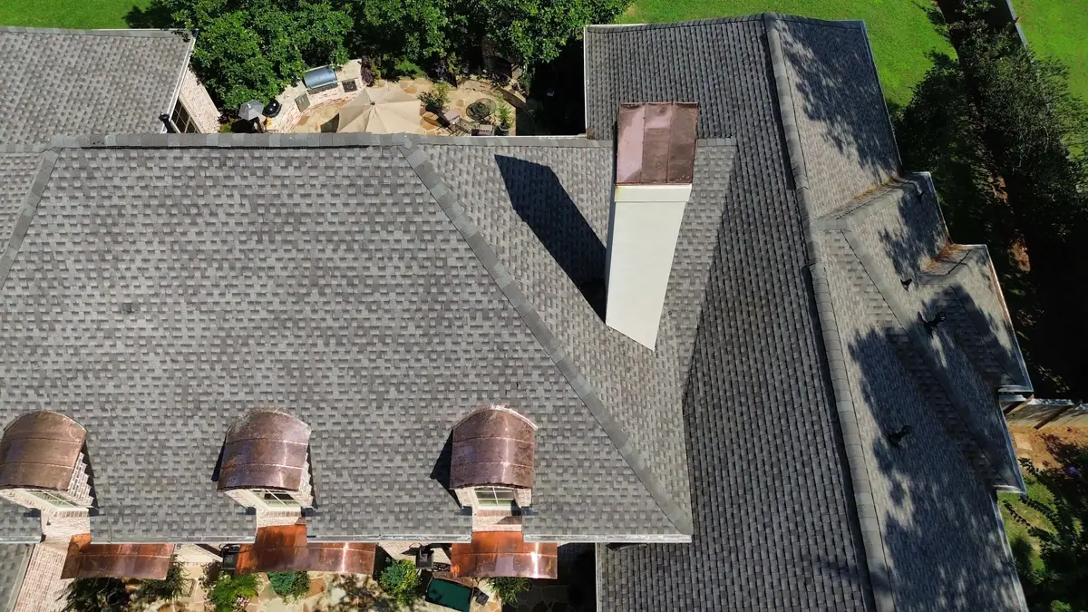 Finished shingle roof with copper eyebrow dormers, from above, residential roofing by Dickerson Contracting serving Pearl, MS