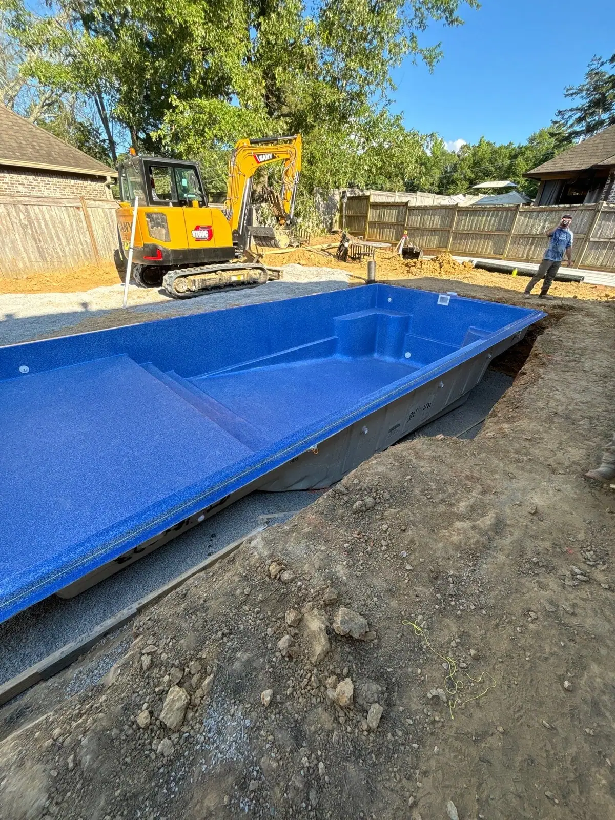 Fiberglass pool shell set into the excavation by DC Pools and Spas, pool company serving Ridgeland, MS