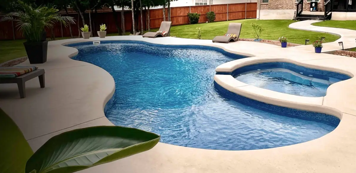 Freeform fiberglass pool with an attached spa (Latham photo), a model DC Pools and Spas installs serving Vicksburg, MS