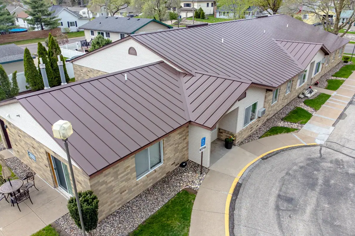 Bronze standing seam metal roof on a single-story brick building, seen from above