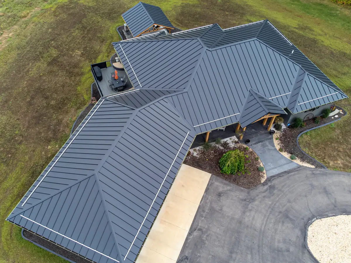 Charcoal standing seam metal roof on a large modern home